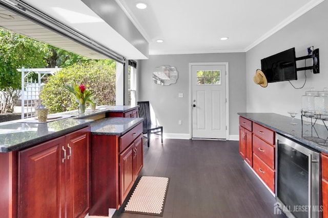 369 N Main St, Milltown, NJ 08850 - kitchen with dark brown cabinets, healthy amount of natural light, dark wood-style floors, crown molding, and wine cooler