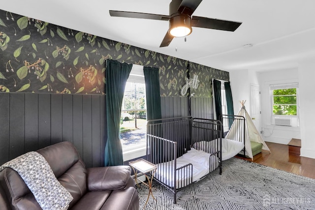 369 N Main St, Milltown, NJ 08850 - bedroom featuring wood finished floors, wallpapered walls, cooling unit, a ceiling fan, and a baseboard radiator