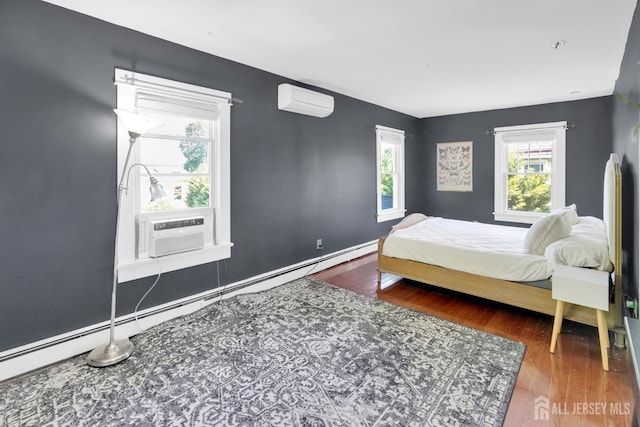 369 N Main St, Milltown, NJ 08850 - bedroom featuring an AC wall unit, wood finished floors, cooling unit, and a baseboard radiator