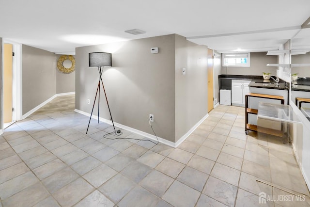 369 N Main St, Milltown, NJ 08850 - kitchen featuring dark countertops, light tile patterned floors, and white cabinets