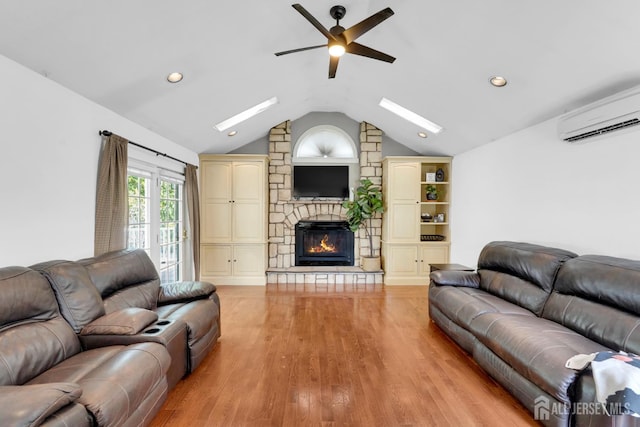 369 N Main St, Milltown, NJ 08850 - living area with a ceiling fan, a skylight, a fireplace, an AC wall unit, and lofted ceiling