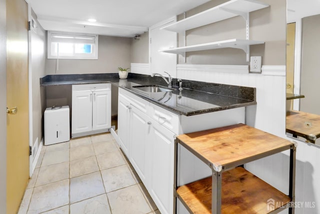 369 N Main St, Milltown, NJ 08850 - kitchen with white cabinets, open shelves, dark stone countertops, and wainscoting