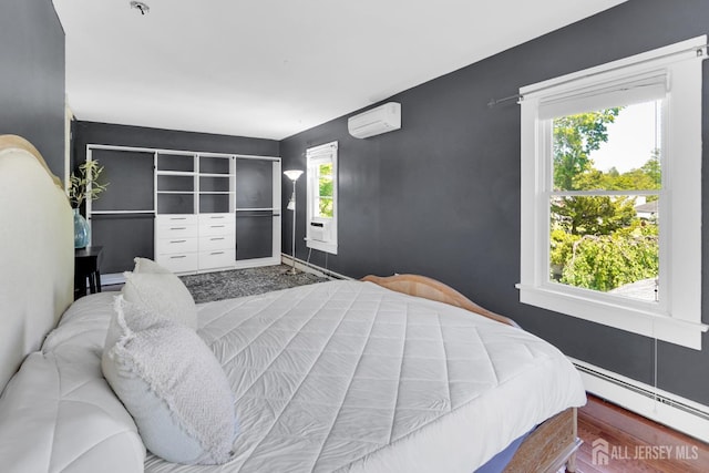 369 N Main St, Milltown, NJ 08850 - bedroom featuring a baseboard radiator and a wall unit AC
