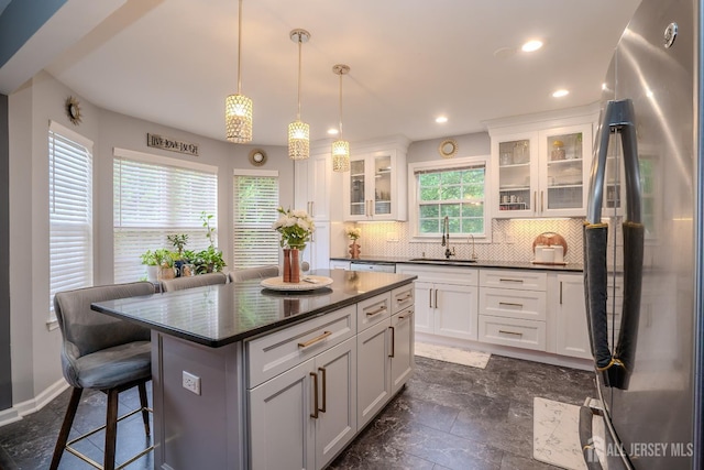 108 Jared Dr, North Brunswick, NJ 08902 - kitchen featuring stainless steel appliances, dark countertops, backsplash, a breakfast bar area, and white cabinets