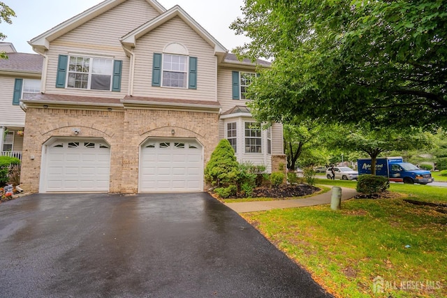 108 Jared Dr, North Brunswick, NJ 08902 - view of front of property featuring asphalt driveway, an attached garage, brick siding, and a front lawn