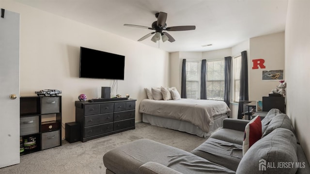 bedroom with carpet floors, visible vents, and ceiling fan