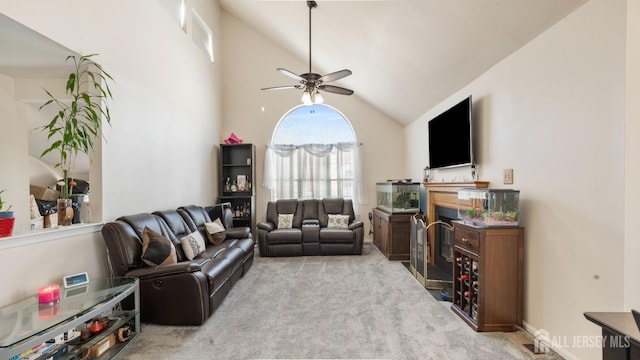 carpeted living room with a ceiling fan and lofted ceiling