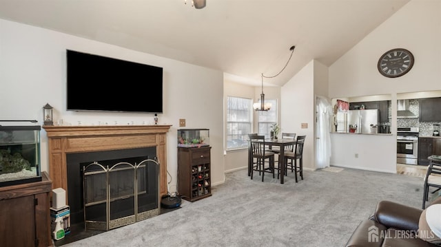 living room with a fireplace, an inviting chandelier, carpet flooring, high vaulted ceiling, and baseboards