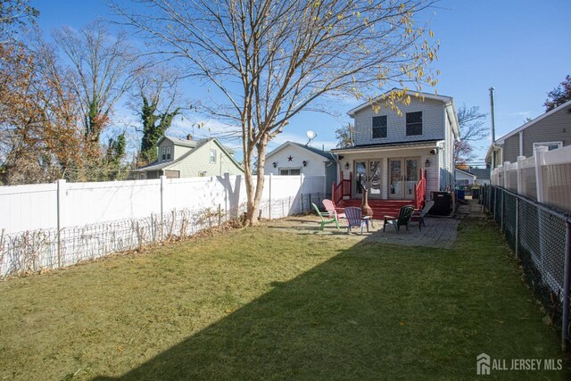 rear view of house with a patio area and a lawn