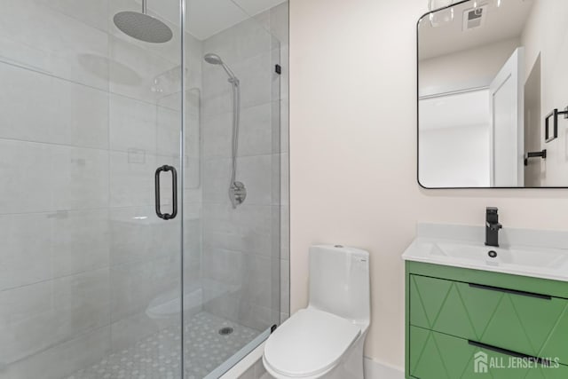 full bath featuring toilet, vanity, and a stall shower