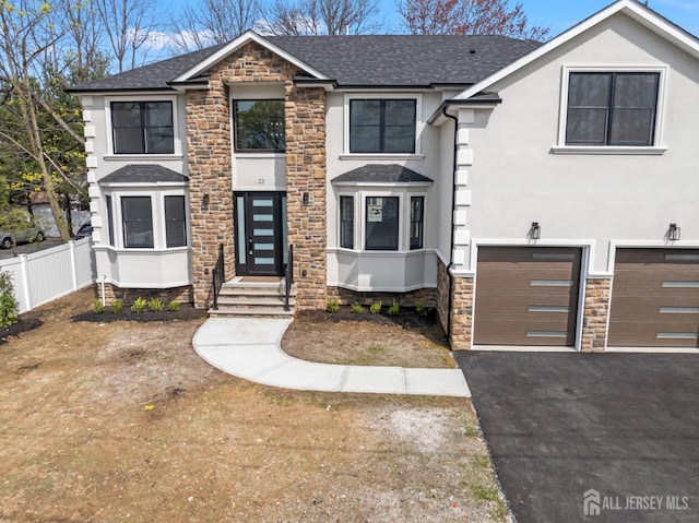 23 Redwood Ave, Edison, NJ 08817 - view of front of property featuring stone siding, roof with shingles, stucco siding, fence, and a garage