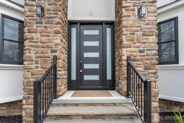property entrance with stone siding