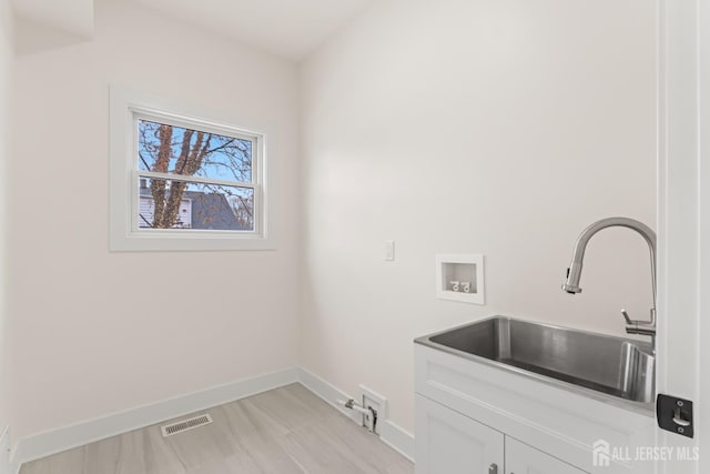 23 Redwood Ave, Edison, NJ 08817 - clothes washing area with cabinet space, baseboards, and washer hookup