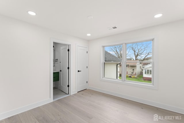 unfurnished bedroom with recessed lighting, visible vents, light wood finished floors, and baseboards