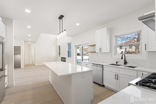 23 Redwood Ave, Edison, NJ 08817 - kitchen featuring appliances with stainless steel finishes, a kitchen island, recessed lighting, light countertops, and healthy amount of natural light