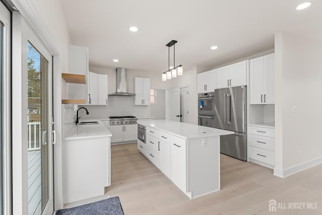 kitchen with a center island, open shelves, a sink, wall chimney exhaust hood, and appliances with stainless steel finishes