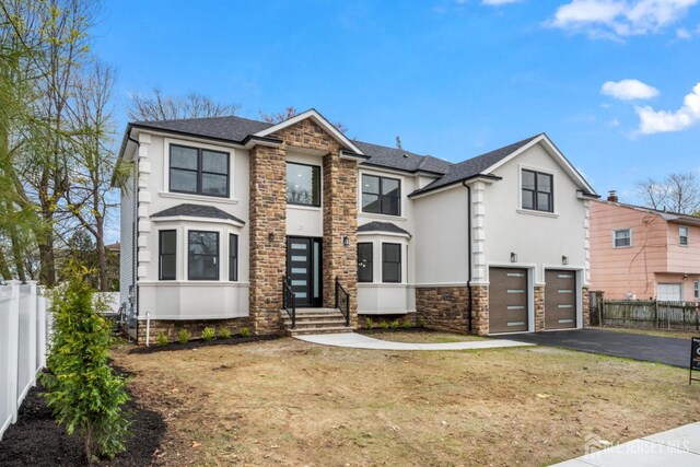23 Redwood Ave, Edison, NJ 08817 - view of front of home featuring stone siding, stucco siding, driveway, a garage, and a shingled roof