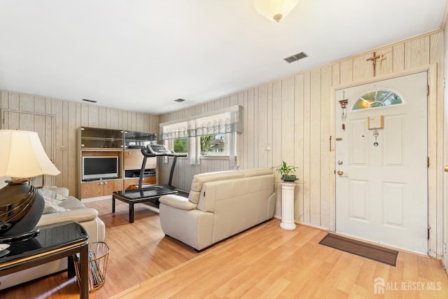 10 Denman Dr, Fords, NJ 08863 - living area featuring wood walls and light wood-style floors