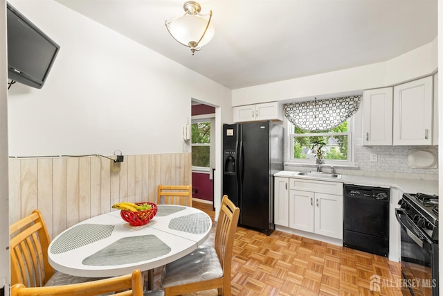 10 Denman Dr, Fords, NJ 08863 - kitchen with black appliances, a wainscoted wall, healthy amount of natural light, light countertops, and white cabinetry