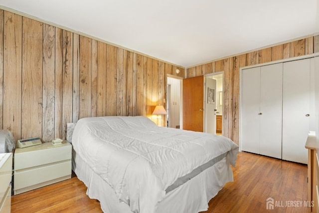 10 Denman Dr, Fords, NJ 08863 - bedroom featuring wood walls, a closet, connected bathroom, and wood finished floors