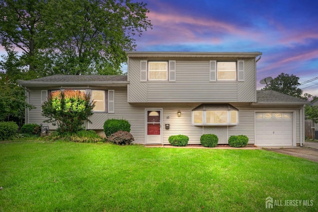 10 Denman Dr, Fords, NJ 08863 - split level home featuring an attached garage, a front yard, driveway, and roof with shingles
