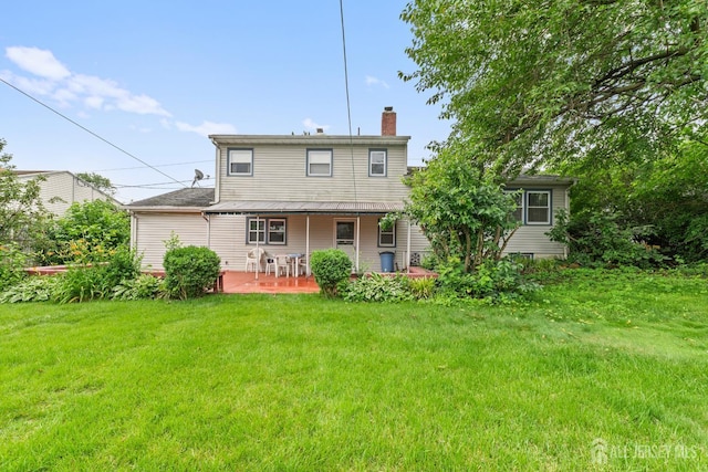 10 Denman Dr, Fords, NJ 08863 - back of house with a chimney, a lawn, and a porch