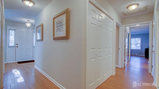 741-B Nautilus Ct Unit B, Monroe, NJ 08831 - hall with a textured ceiling, light wood finished floors, baseboards, and a baseboard heating unit