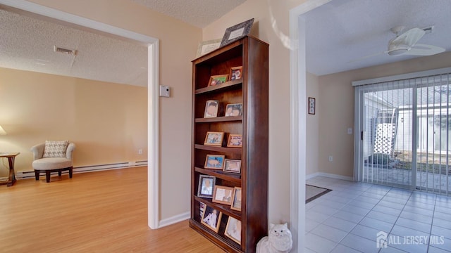 741-B Nautilus Ct Unit B, Monroe, NJ 08831 - hallway featuring a textured ceiling, light wood-type flooring, baseboard heating, and baseboards