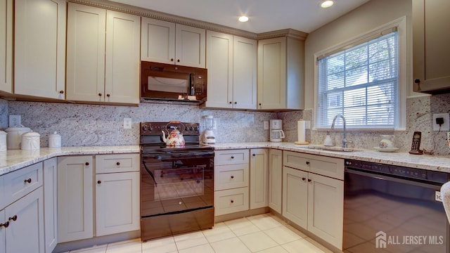 741-B Nautilus Ct Unit B, Monroe, NJ 08831 - kitchen with black appliances, backsplash, a sink, light tile patterned floors, and light stone countertops