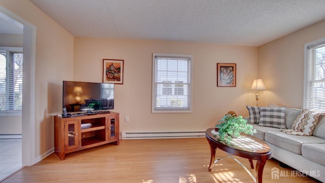 741-B Nautilus Ct Unit B, Monroe, NJ 08831 - living room featuring a baseboard radiator, light wood finished floors, baseboard heating, and a textured ceiling