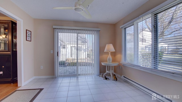 741-B Nautilus Ct Unit B, Monroe, NJ 08831 - tiled spare room featuring a baseboard heating unit, plenty of natural light, ceiling fan, a textured ceiling, and baseboards