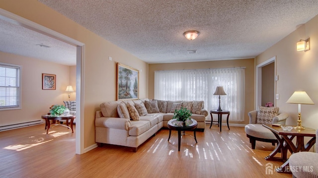 741-B Nautilus Ct Unit B, Monroe, NJ 08831 - living room with a textured ceiling, light wood finished floors, baseboard heating, and baseboards