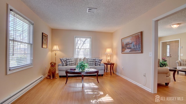 741-B Nautilus Ct Unit B, Monroe, NJ 08831 - sitting room with a baseboard radiator, a textured ceiling, light wood finished floors, and baseboards