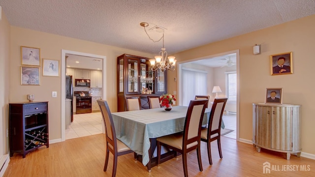 741-B Nautilus Ct Unit B, Monroe, NJ 08831 - dining space with a chandelier, light wood-style flooring, a textured ceiling, and baseboards