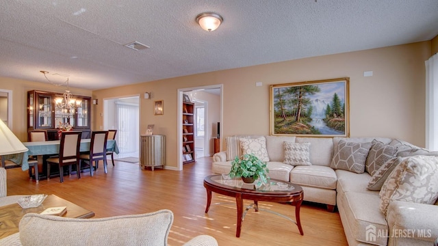 741-B Nautilus Ct Unit B, Monroe, NJ 08831 - living area with a textured ceiling, a chandelier, and light wood-type flooring