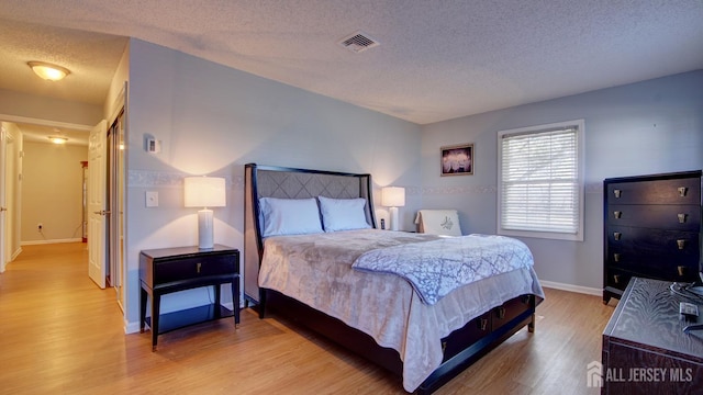741-B Nautilus Ct Unit B, Monroe, NJ 08831 - bedroom with a textured ceiling, light wood finished floors, and baseboards