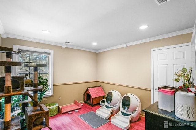 game room with ornamental molding and hardwood / wood-style floors