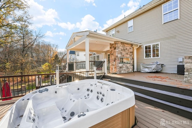 wooden terrace with a hot tub