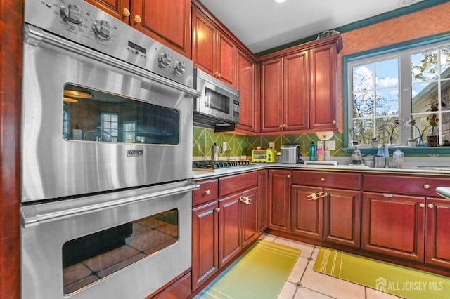 kitchen featuring stainless steel appliances and decorative backsplash