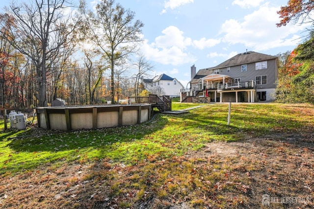 view of yard with a pool side deck