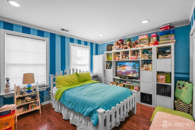 bedroom featuring ornamental molding and dark hardwood / wood-style flooring