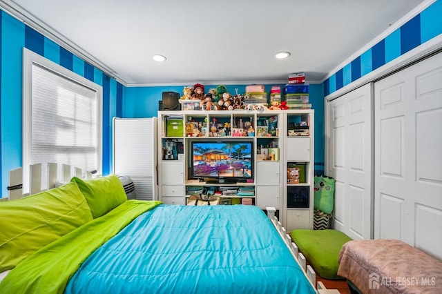 bedroom featuring ornamental molding and a closet