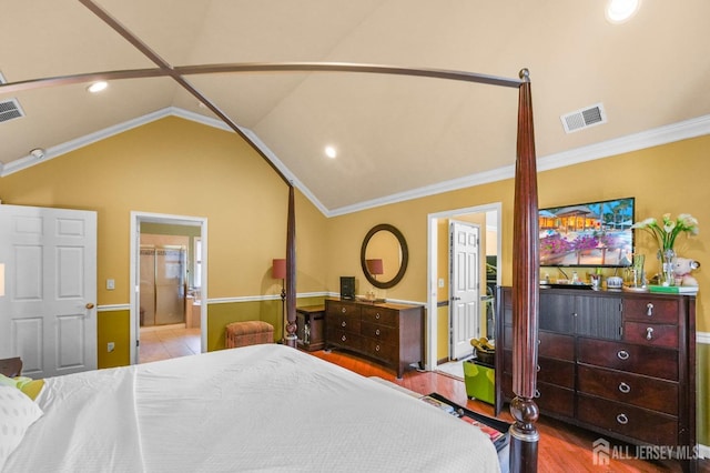 bedroom with crown molding, ensuite bath, lofted ceiling, and light wood-type flooring