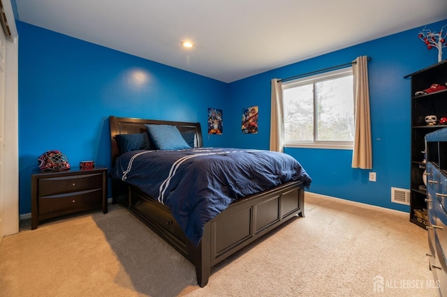 bedroom with carpet floors, visible vents, and baseboards