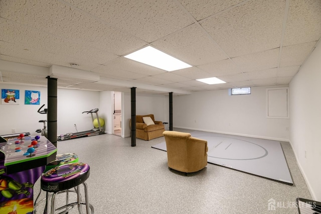 playroom featuring a paneled ceiling and baseboards