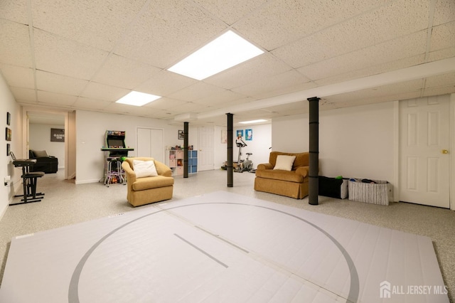 finished basement featuring a paneled ceiling