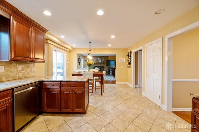 kitchen with recessed lighting, decorative backsplash, a large fireplace, dishwasher, and a peninsula