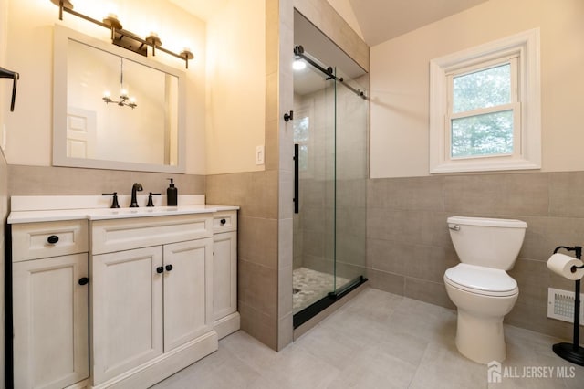 full bath with tile walls, visible vents, toilet, a stall shower, and vanity