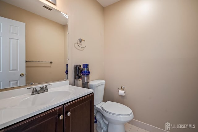 58 La Rue Ln, East Brunswick, NJ 08816 - bathroom featuring tile patterned flooring, toilet, vanity, and baseboards