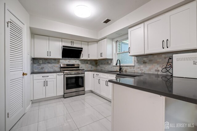 58 La Rue Ln, East Brunswick, NJ 08816 - kitchen with gas stove, a sink, dark countertops, and white cabinetry